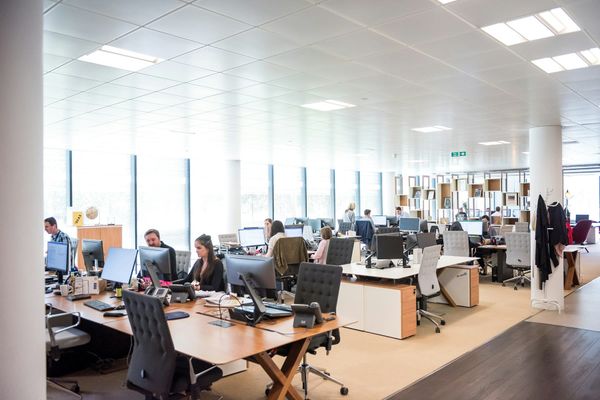 People working at desks in an open plan office
