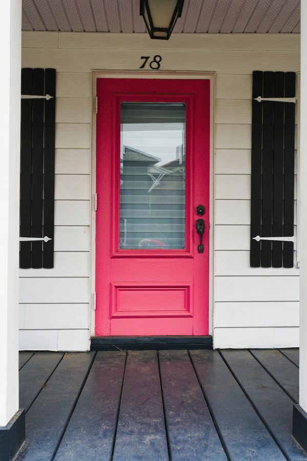 A red front door on a white house