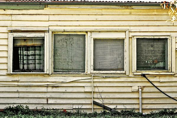 An old run down house with a broken window