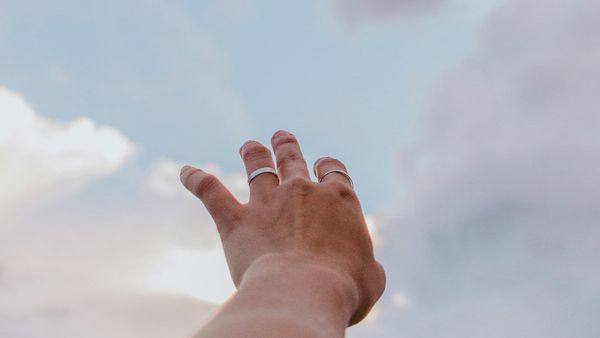 Hand reaching towards the heavens