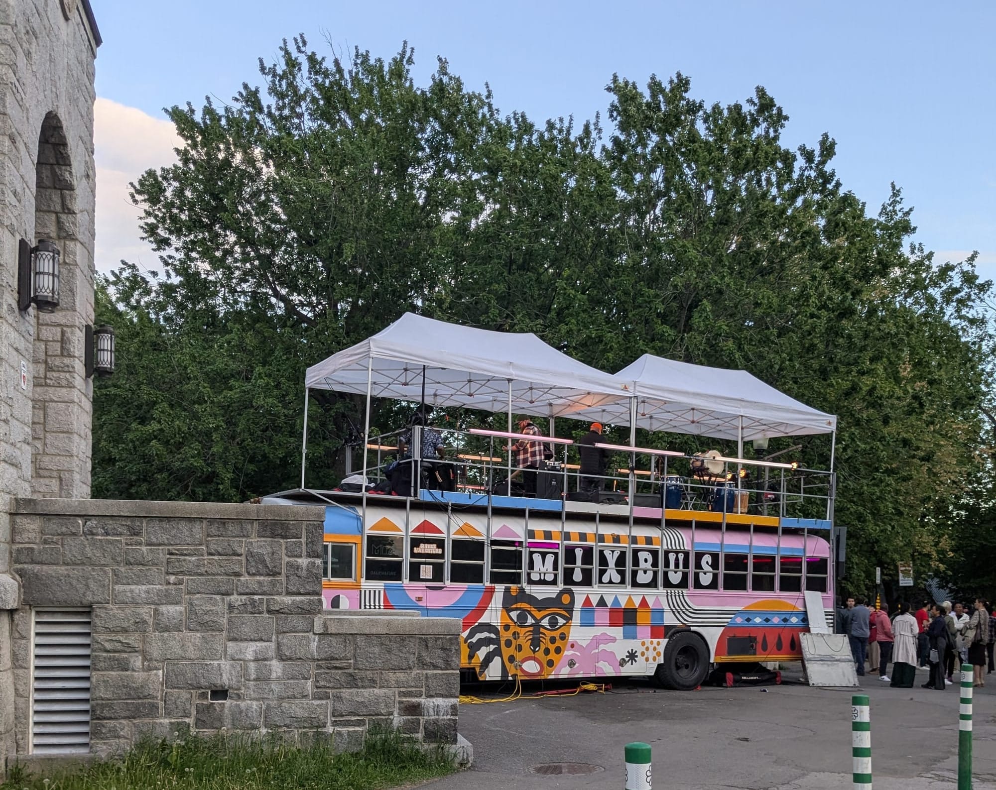 photo: Le Mixbus (painted bus with a stage and canopy on top)