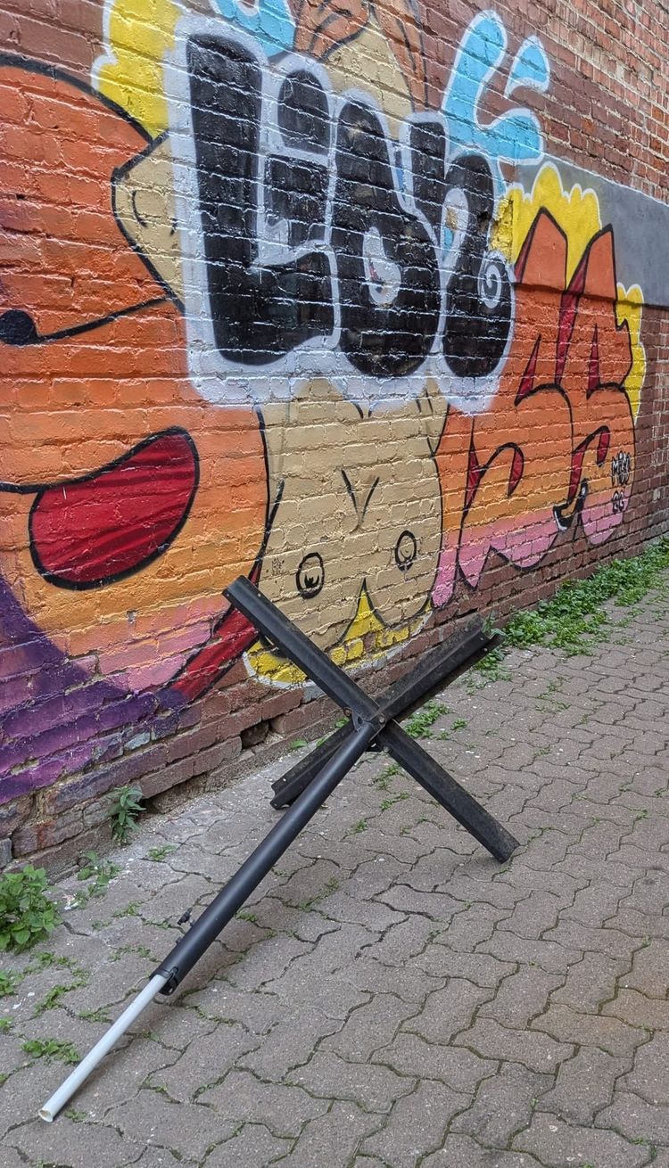 photo: restaurant table looking like a czech hedgehog in an alley with some graffiti