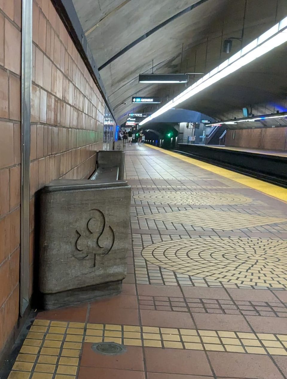 photo: metro platform w/ fleur-de-lis engraved on bench support