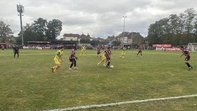 Clapton CFC and Great Wakering Rovers in midfield at the Old Spotted Dog, terraced houses and a packed far side behind