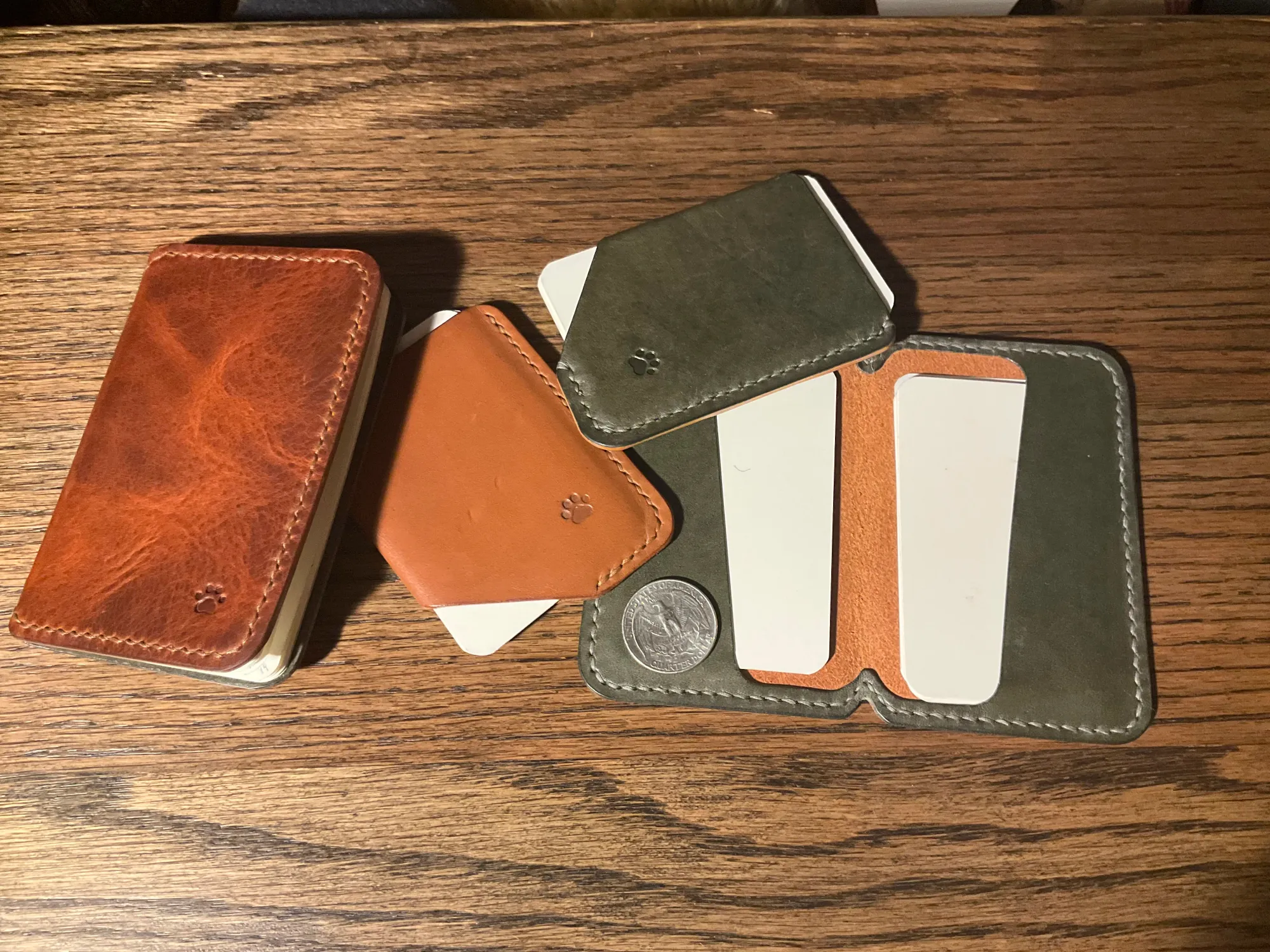 portfolio Picture showing various homemade leather goods, including notebook covers, wallets, and index card holders