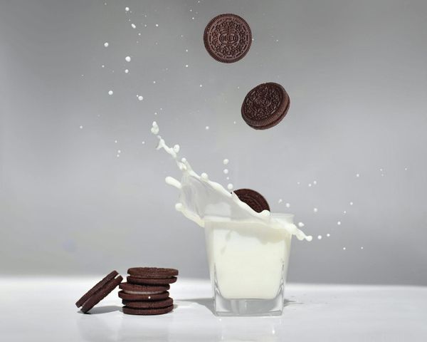 cookies falling into a glass of milk