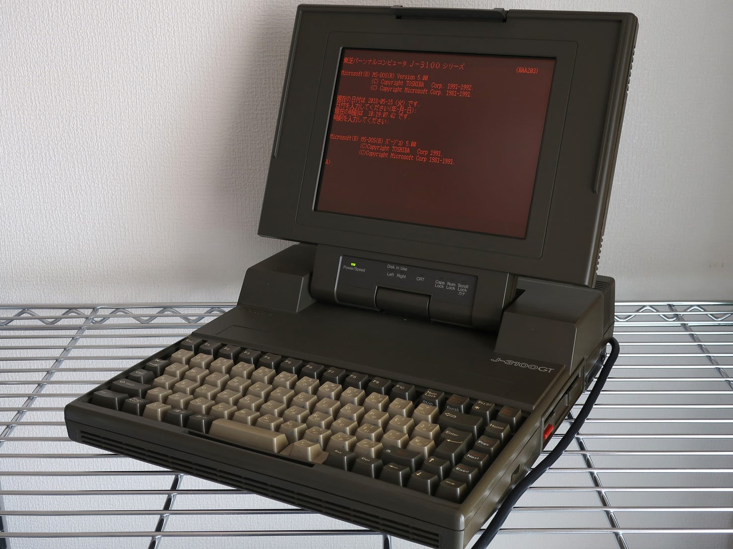 A Toshiba T3100 laptop with an orange plasma display