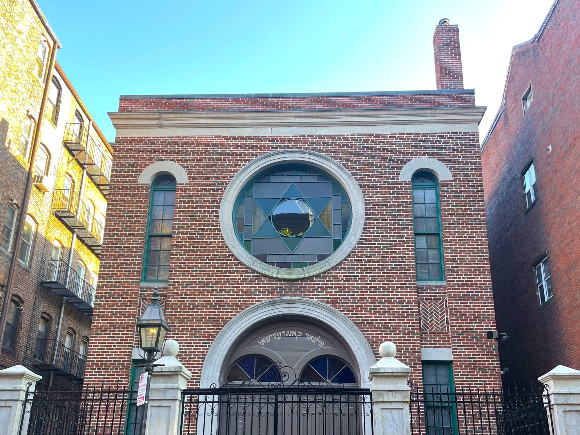 Two-story urban brick synagogue with a large Star of David stained glass window
