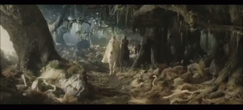 Merry and Pippin on the wall of Isengard, celebrating and cheering.