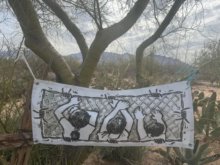 A drawing of three children trying to climb a chain-link fence
