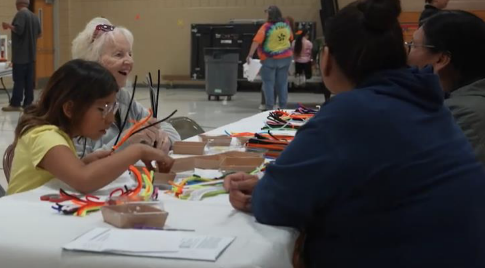 A family sits at a table working on an art project during family night at a Sioux Falls Community Learning Center.