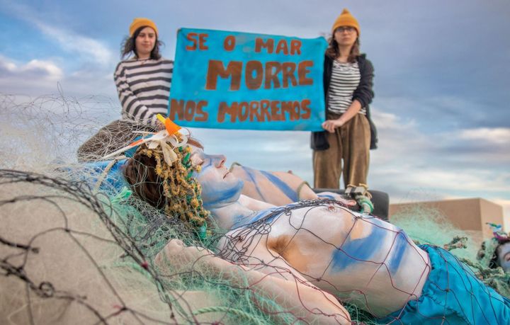 Mermaid lies dead on Lisbon's urban beach.