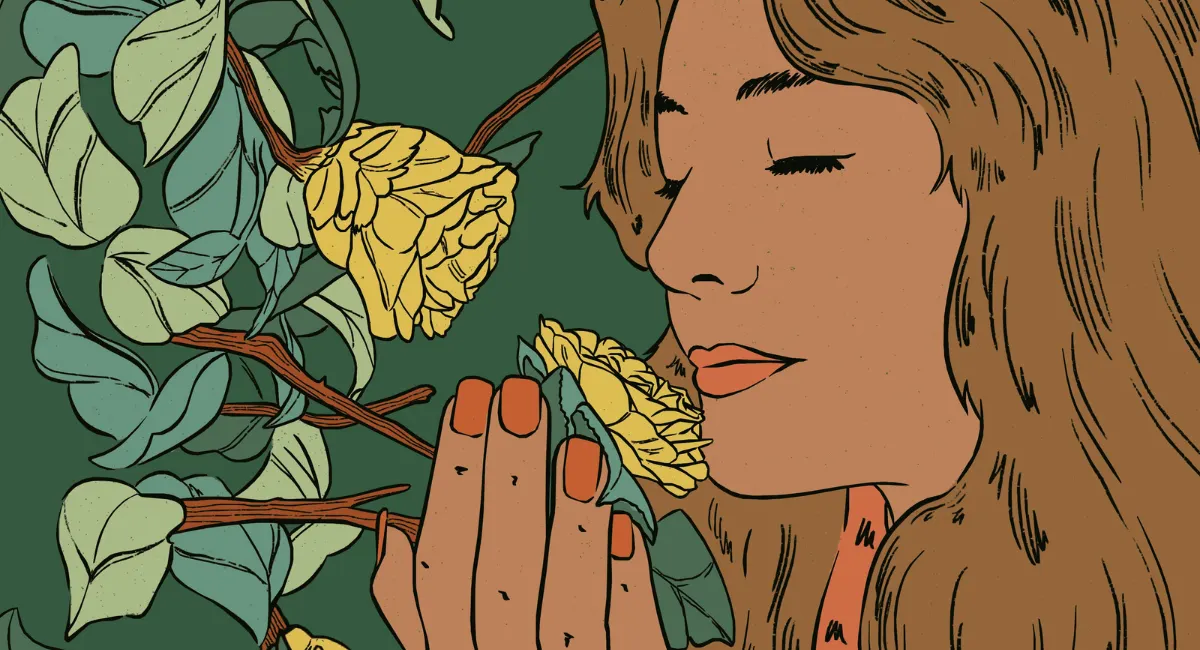 Femme qui sent une fleur