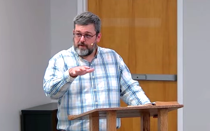 Pastor Jake Reid teaching from 1 Corinthians 12 at Easton Baptist Church