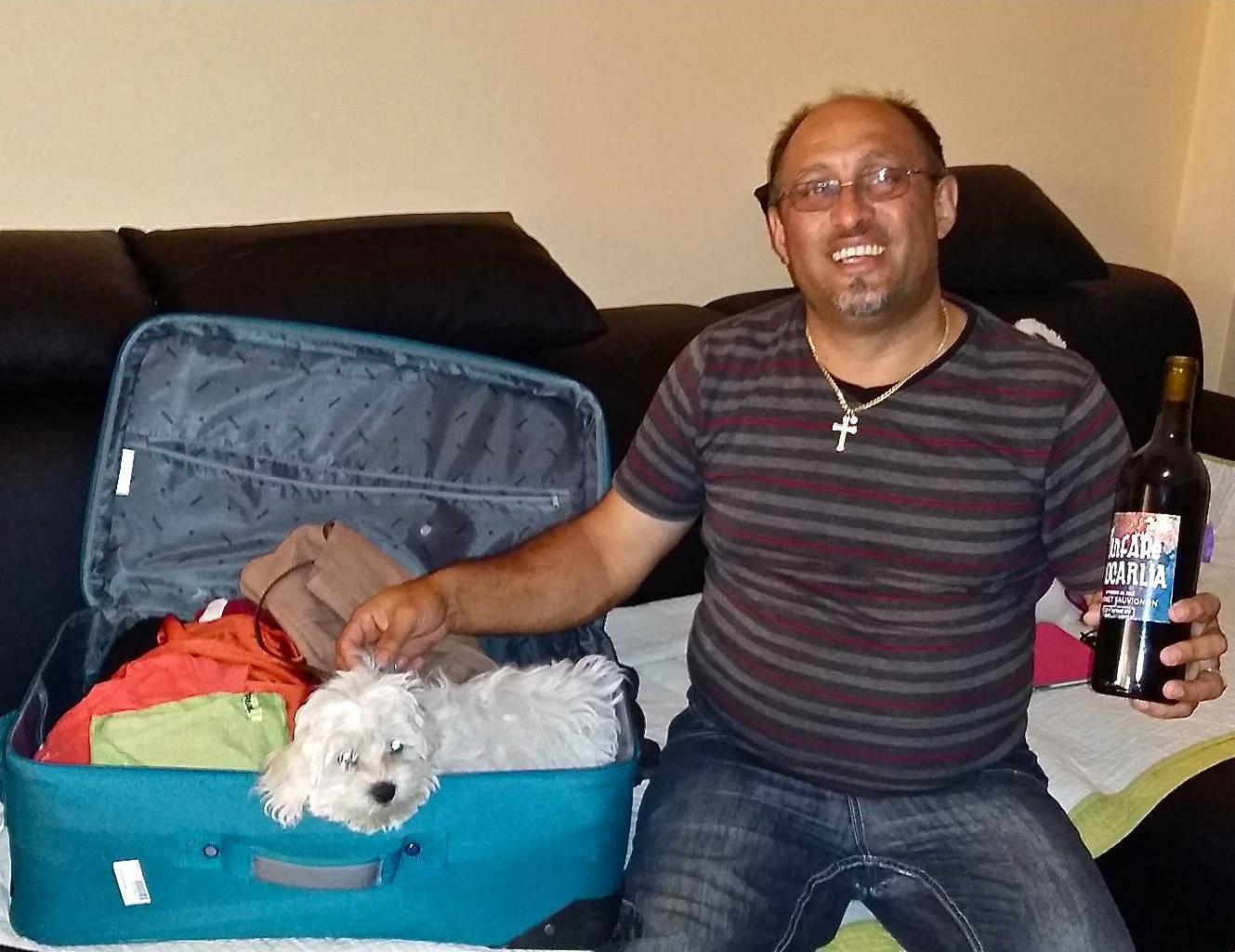 Oprica holding bottle of Fanfare Ciocarlia branded wine