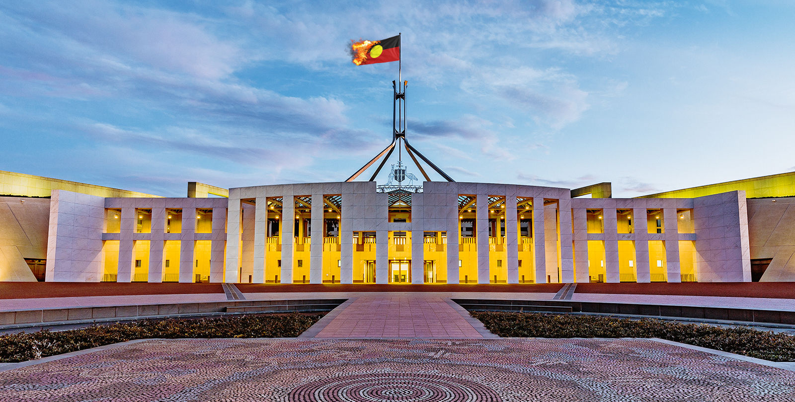 The Aboriginal flag burning atop Parliament House