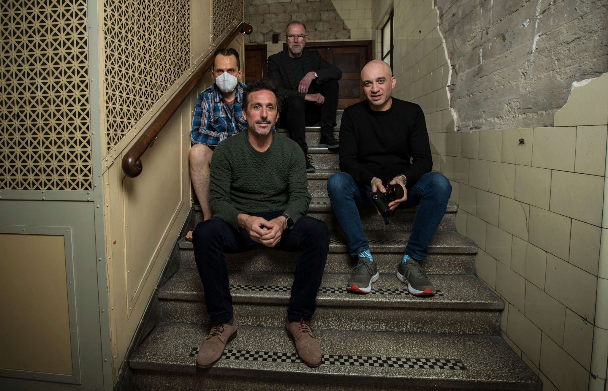 Four people sitting in a stairwell in the Nicholas Building, only yours truly wearing a respirator