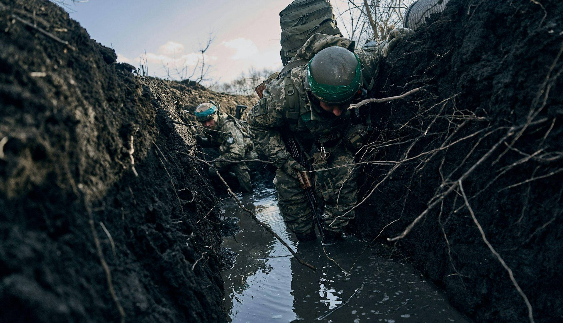 Soldiers in a water-logged Ukrainian trench