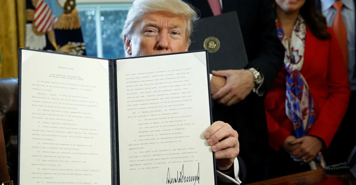 President Trump holding up an Executive Order just signed by him