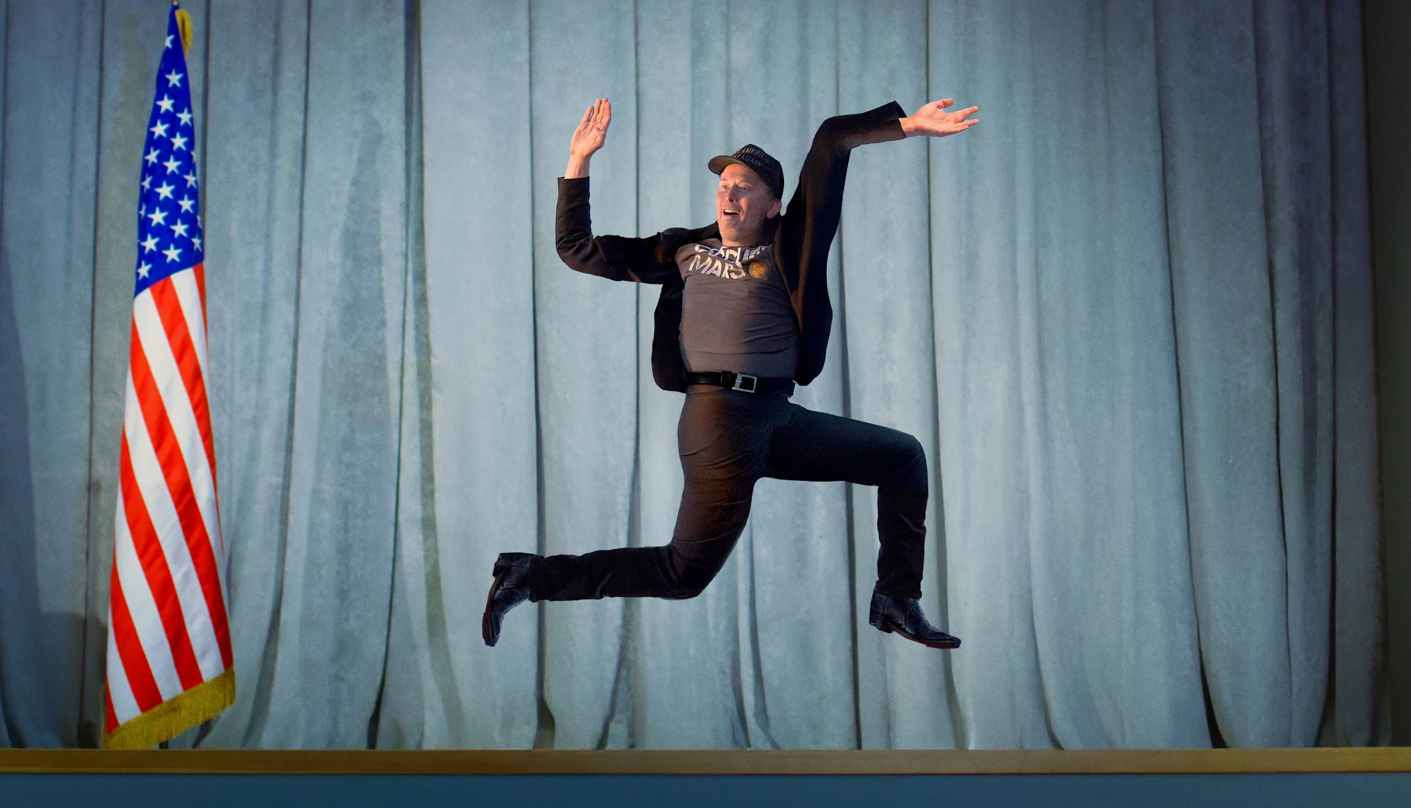 Elon Musk jumping in the air (as he often has), his limbs photoshopped so that he appears to be a human swastika
