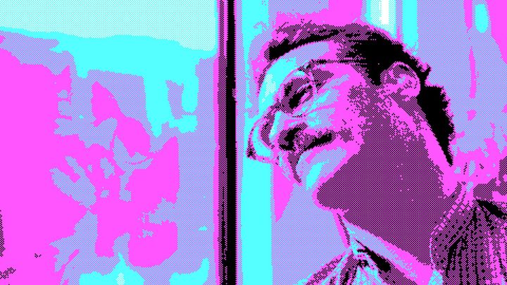 A still from the movie Her. The protagonist is leaning against a window, dreaming. He has an AI assistant in his ear.