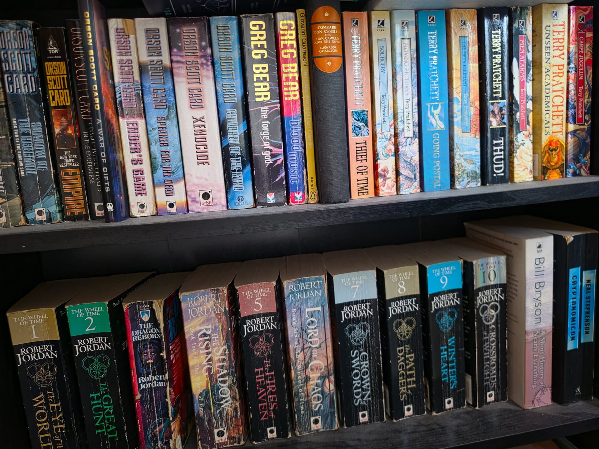 A lot of very old, dusty books on a shelf. Maybe it's just the shelf that is dusty.