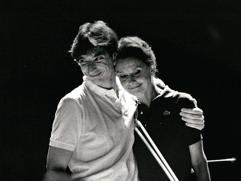 A black and white photo of a young Michael Tilson Thomas with his arm around Audrey Hepburn.