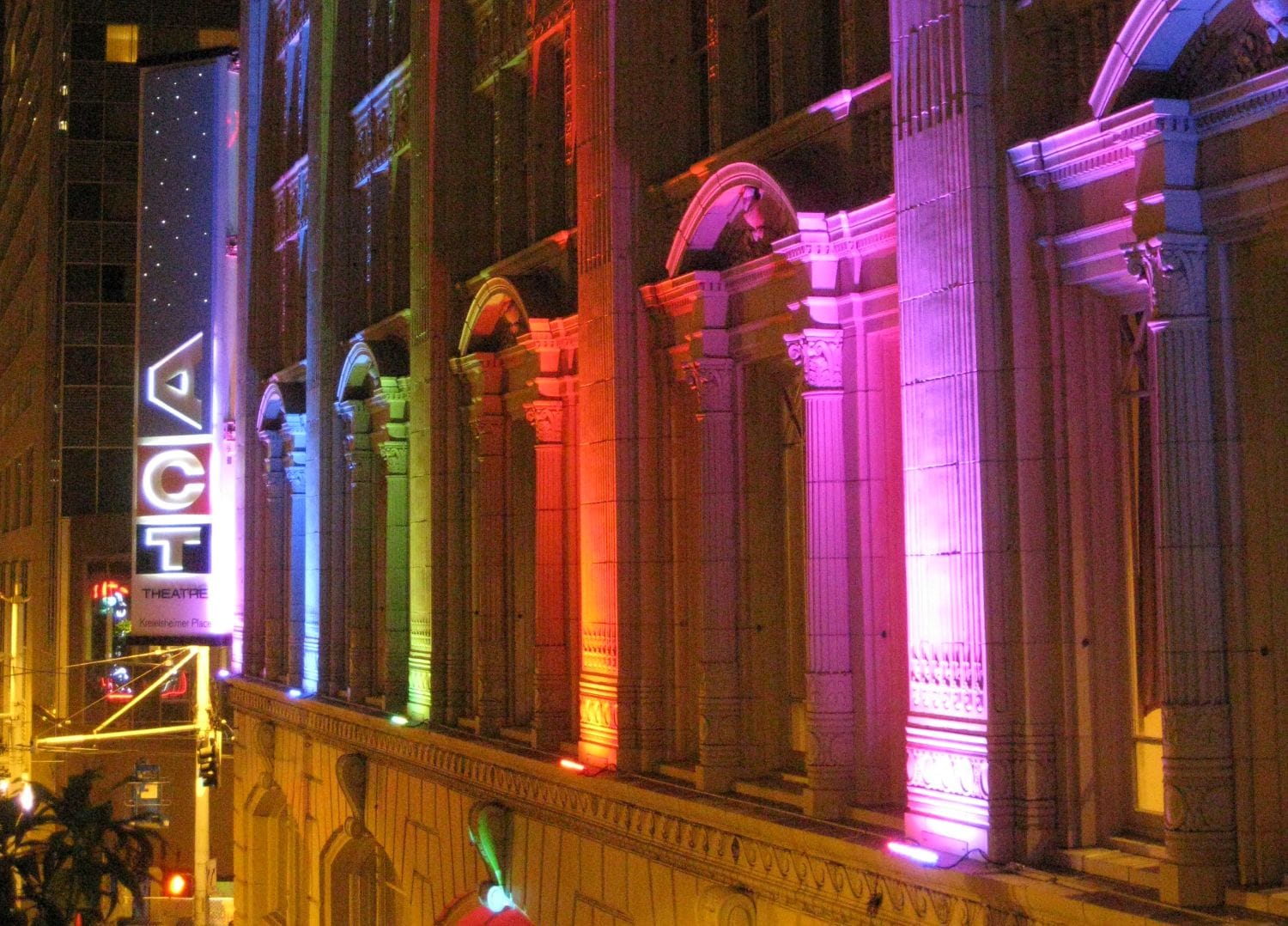 The outside of ACT Theatre light up with rainbow lights.