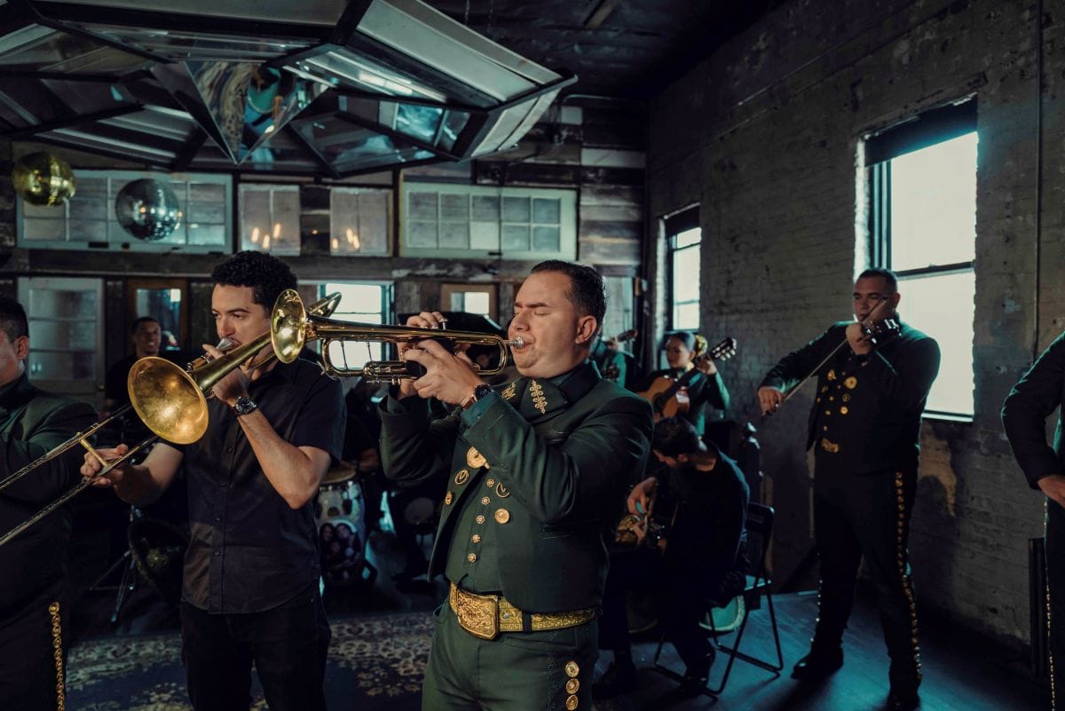 A mariachi band plays in a warehouse.