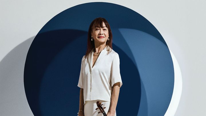 Mariko Smiley, Acting Assistant Concertmaster in front of a dark blue circle on a white backdrop