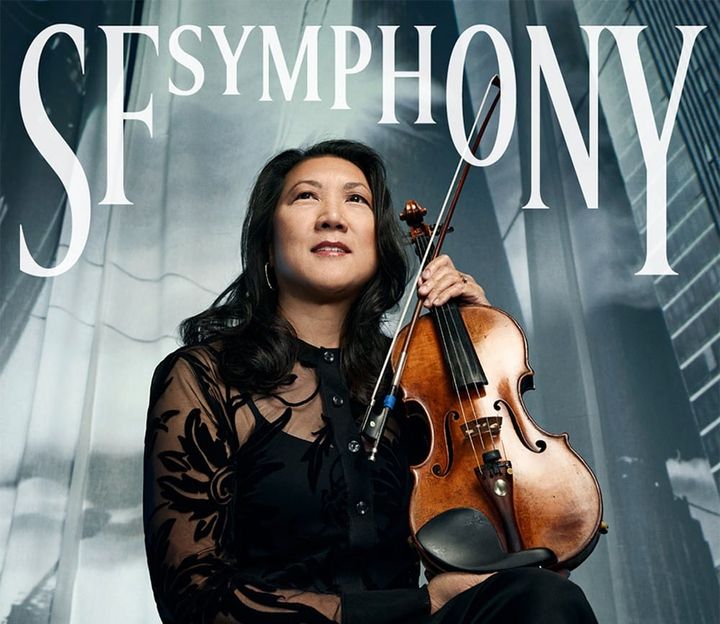 A musician sits with her violin.