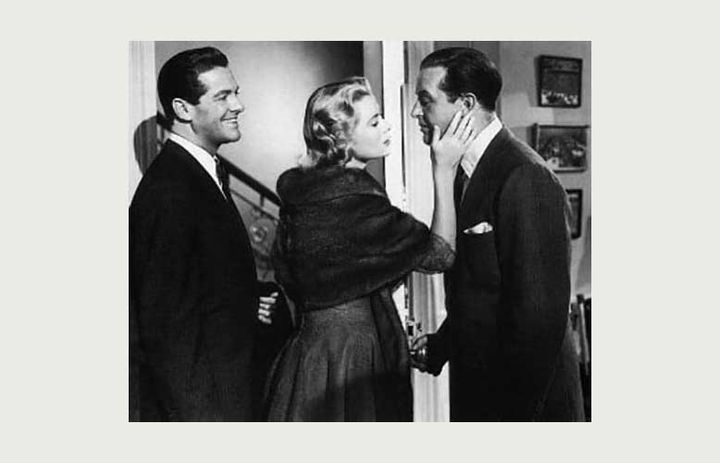 A black and white photo from the film "Dial M for Murder". A woman stands between two men.