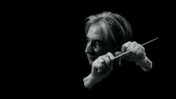 A black and white image of MTT conducting with his eyes closed.