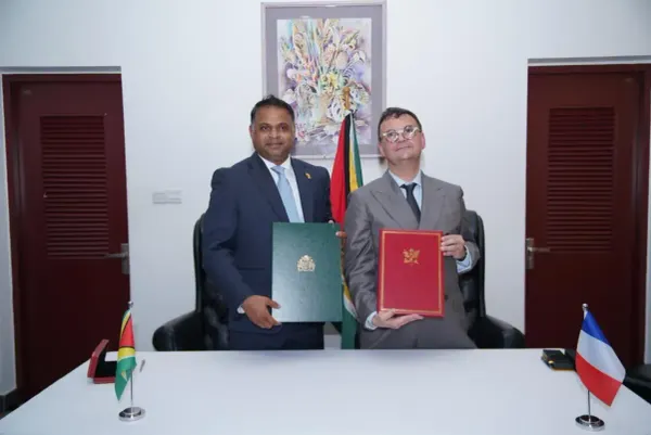 Guyana aviation minister Deodat Indar and French Ambassador Olivier Plançon during the signing of a renewed air services agreement.
