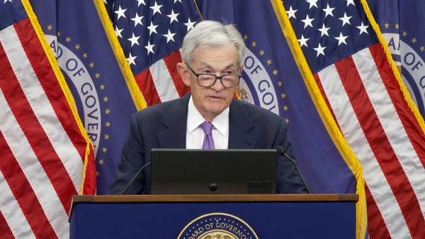 Fed Chair Jerome Powell on October 29th, 2025 standing at a podium in front of some American flags