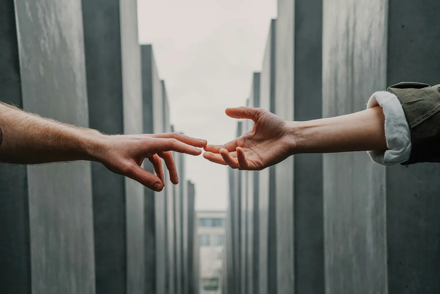 Two hands reaching out to touch