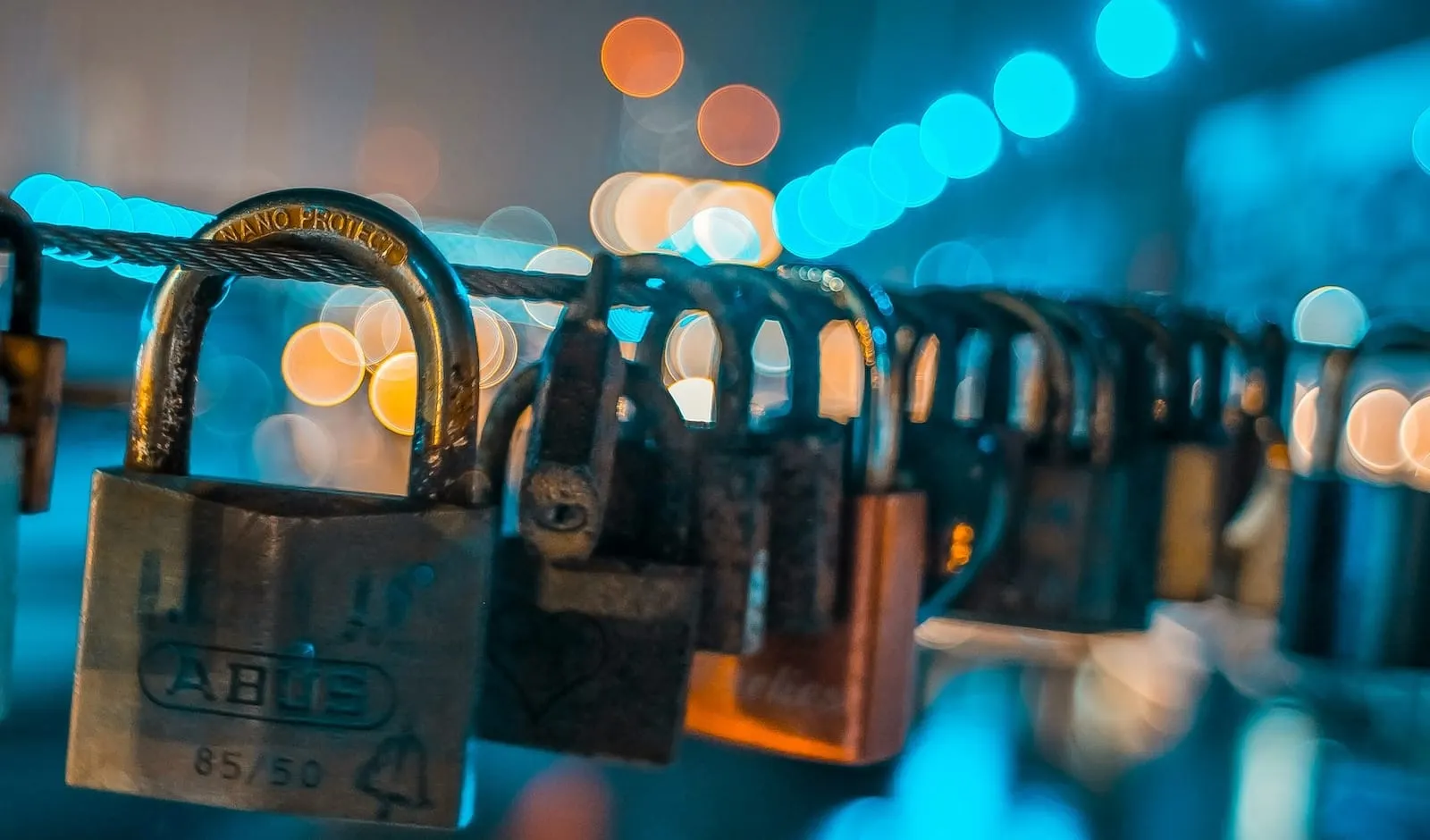 Metal padlocks hanging from cable