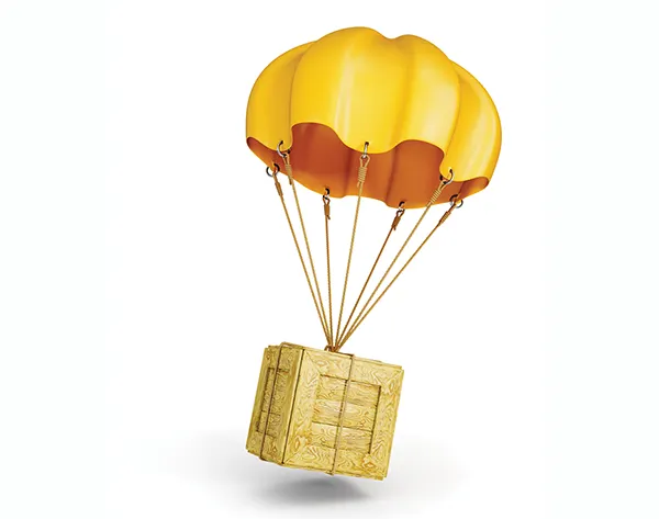 Wooden box floating down to ground with parachute