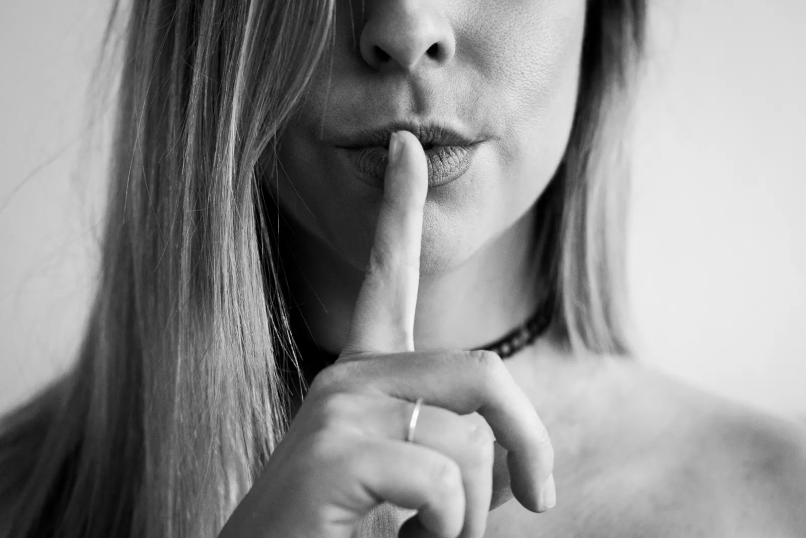 Woman making quiet sign with finger