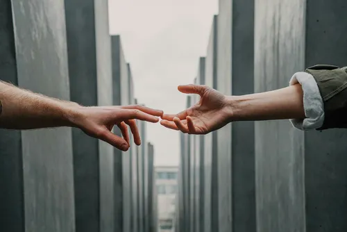 Two hands reaching out to touch