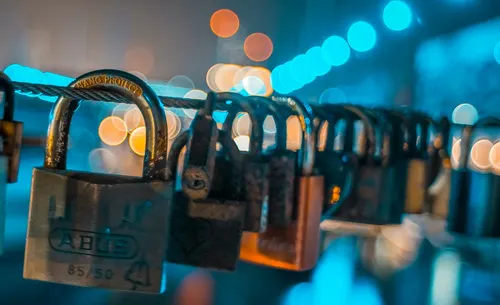 Metal padlocks hanging from cable