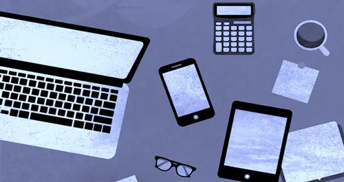 Laptop and other devices on gray-blue background