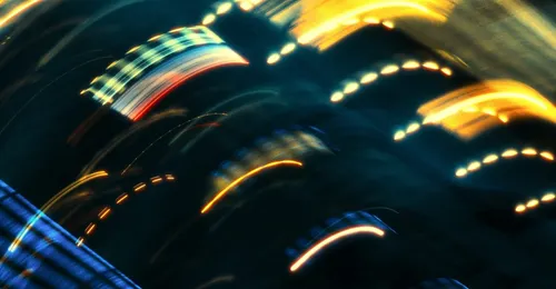 Yellow and orange arcing lights on black background