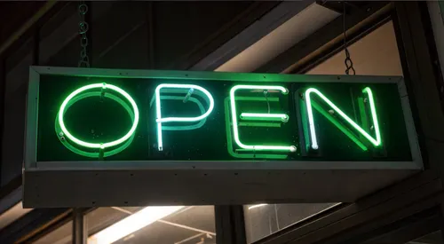 Green neon sign that says open