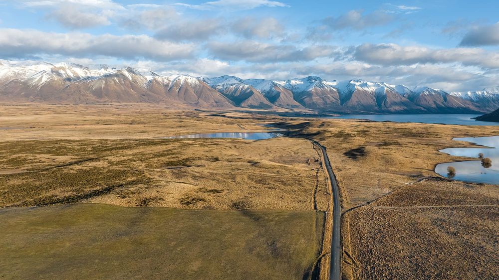 Drone perspective of the road out to Lake Ohau post image