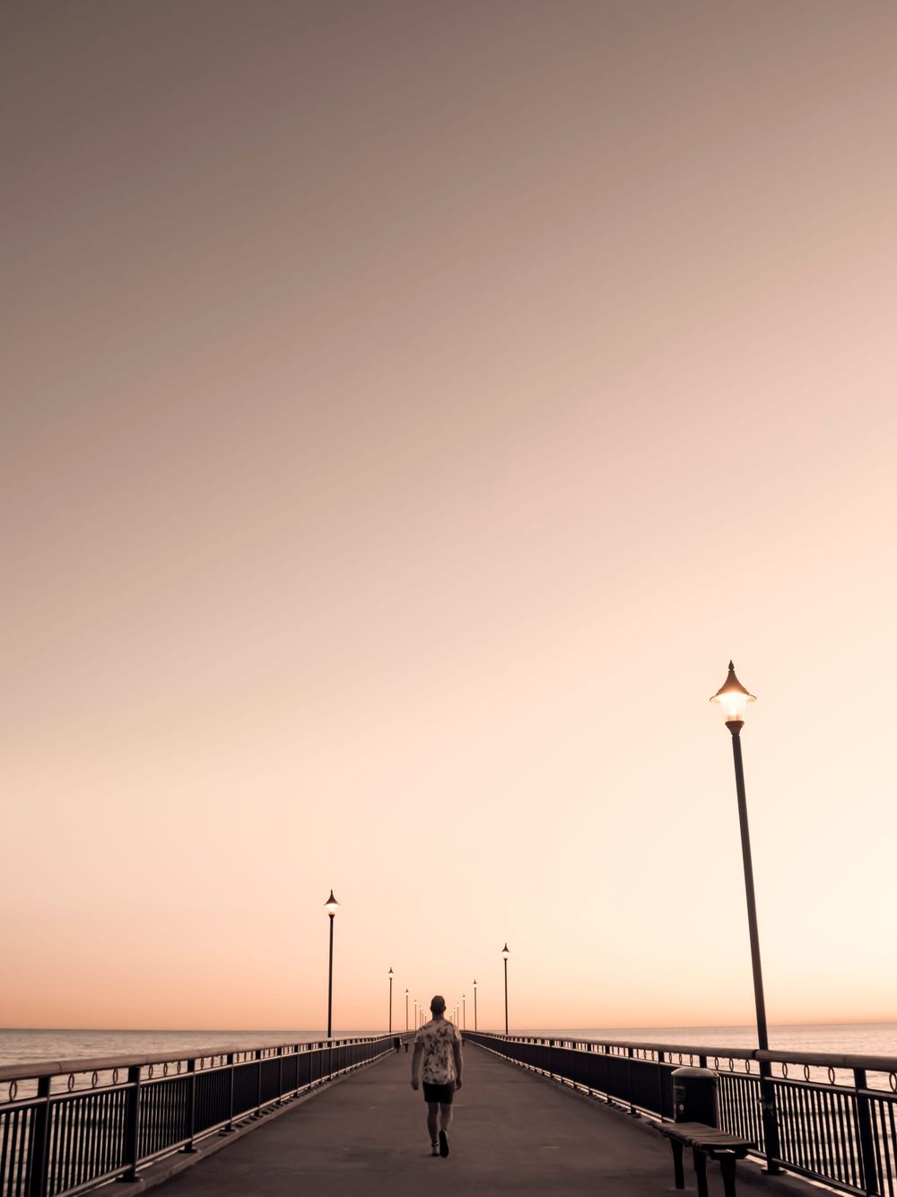 Man walking pier symmetrical creative post image