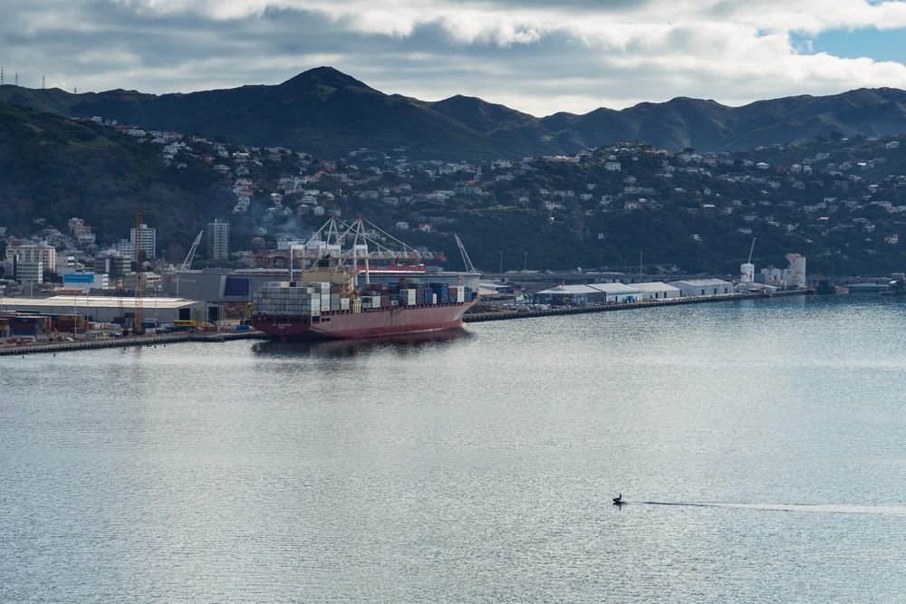Cargo ship docked at port with hills behind post image