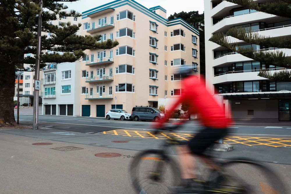 Cyclist passing apartments post image