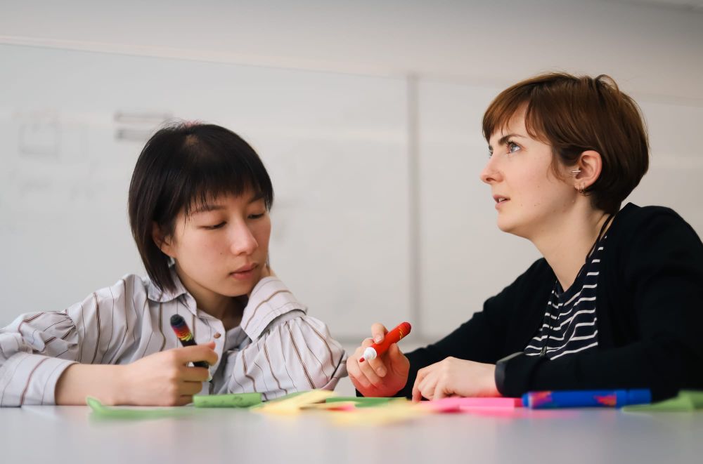 Team members writing ideas during a workshop post image