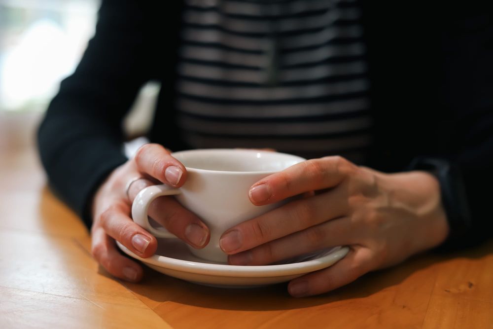Hands holding cup of coffee post image